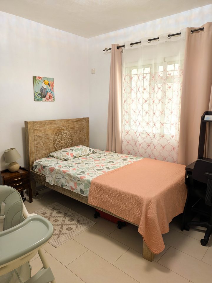 Family bedroom with rustic carved bed